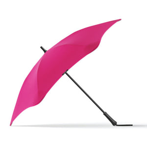 A pink umbrella with a fabric handle strap, displayed in its open position.